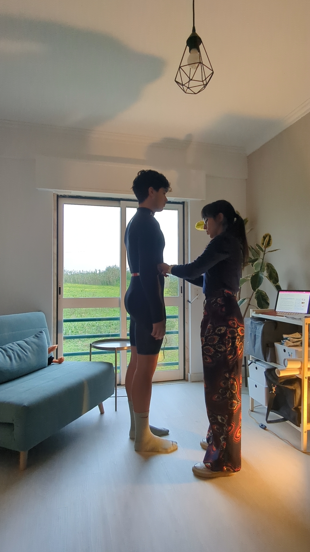 Tailor measuring client for custom trousers at Tahio Avila